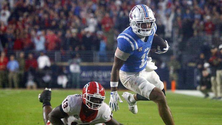 Nov 9, 2024; Oxford, Mississippi, USA; Mississippi Rebels wide receiver Jordan Watkins (11) breaks a tackle attempt by Georgia Bulldogs defensive lineman Mykel Williams (13), after a catch during the second half at Vaught-Hemingway Stadium. Mandatory Credit: Petre Thomas-Imagn Images