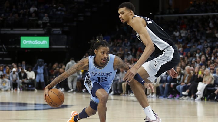 Jan 2, 2024; Memphis, Tennessee, USA; Memphis Grizzlies guard Ja Morant (12) drives to the basket as San Antonio Spurs center Victor Wembanyama (1) defends during the first half at FedExForum. Mandatory Credit: Petre Thomas-Imagn Images
