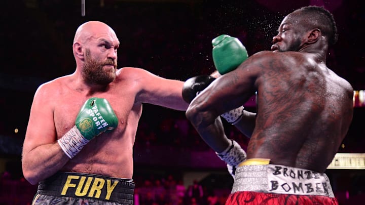 Deontay Wilder (red/black trunks) and Tyson Fury (black/gold trunks) box during their WBC/Lineal heavyweight championship boxing match at T-Mobile Arena. 