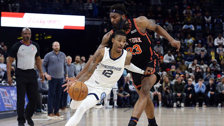 Mar 11, 2022; Memphis, Tennessee, USA; Memphis Grizzlies guard Ja Morant (12) dribbles as New York Knicks center Mitchell Robinson (23) defends during the second half at FedExForum. Mandatory Credit: Petre Thomas-USA TODAY Sports Mar 11, 2022; Memphis, Tennessee, USA; Memphis Grizzlies guard Ja Morant (12) dribbles as New York Knicks center Mitchell Robinson (23) defends during the second half at FedExForum. Mandatory Credit: Petre Thomas-USA TODAY Sports