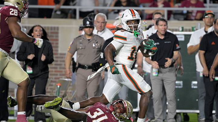 Oct 4, 2025; Tallahassee, Florida, USA; Miami Hurricanes wide receiver Malachi Toney (10) runs against Florida State Seminoles defensive lineman James Williams (10) during the first half at Doak S. Campbell Stadium. Mandatory Credit: Melina Myers-Imagn Images
