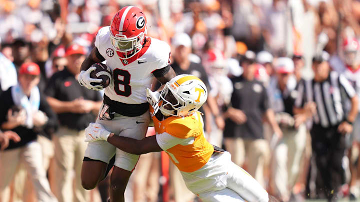 Tennessee defensive back Ty Redmond (4) grabs Georgia wide receiver Colbie Young (8) during an NCAA college football game on September 13, 2025, Knoxville, Tennessee.