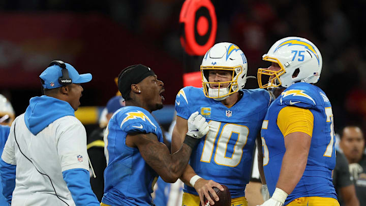 Sep 5, 2025; Justin Herbert (10) and Bradley Bozeman (75) celebrate after the game against the Kansas City Chiefs at Corinthians Arena
