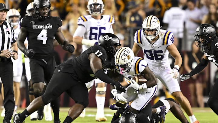 Oct 26, 2024; College Station, Texas, USA; Texas A&M Aggies defensive back Marcus Ratcliffe (3) and defensive lineman Albert Regis (17) tackle LSU Tigers wide receiver Aaron Anderson (1) during the third quarter. The Aggies defeated the Tigers 38-23; at Kyle Field. Mandatory Credit: Maria Lysaker-Imagn Images. Oct 26, 2024; College Station, Texas, USA; Texas A&M Aggies defensive back Marcus Ratcliffe (3) and defensive lineman Albert Regis (17) tackle LSU Tigers wide receiver Aaron Anderson (1) during the third quarter. The Aggies defeated the Tigers 38-23; at Kyle Field. Mandatory Credit: Maria Lysaker-Imagn Images.