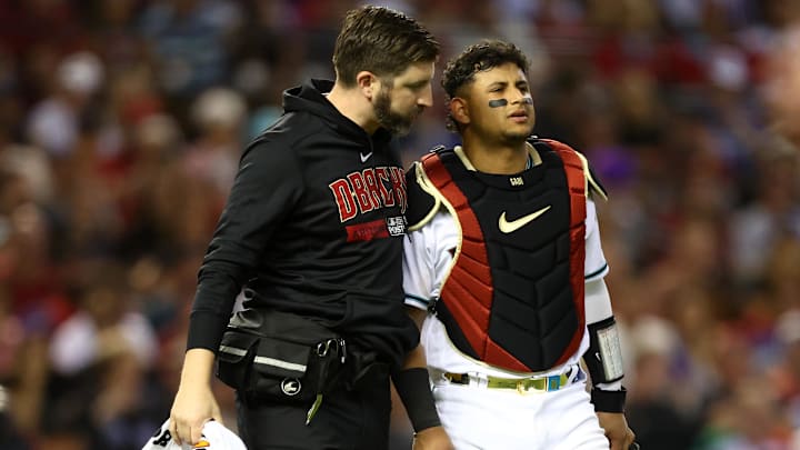 Oct 11, 2023; Phoenix, Arizona, USA; Arizona Diamondbacks catcher Gabriel Moreno (14) is tended to by athletic trainers in the fifth inning for game three of the NLDS for the 2023 MLB playoffs against the Los Angeles Dodgers at Chase Field. Mandatory Credit: Mark J. Rebilas-Imagn Images Oct 11, 2023; Phoenix, Arizona, USA; Arizona Diamondbacks catcher Gabriel Moreno (14) is tended to by athletic trainers in the fifth inning for game three of the NLDS for the 2023 MLB playoffs against the Los Angeles Dodgers at Chase Field. Mandatory Credit: Mark J. Rebilas-Imagn Images