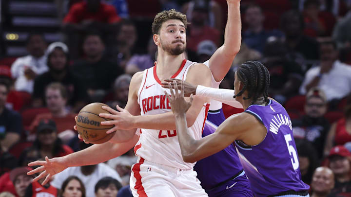 Oct 8, 2025; Houston, Texas, USA; Houston Rockets center Alperen Sengun (28) controls the ball as Utah Jazz forward Cody Williams (5) defends during the second quarter at Toyota Center. Mandatory Credit: Troy Taormina-Imagn Images
