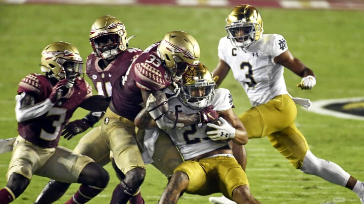 Sep 5, 2021; Tallahassee, Florida, USA; Florida State Seminoles linebacker Amari Gainer (33) tackles Notre Dame Fighting Irish running back Kyren Williams (23) during the first quarter at Doak S. Campbell Stadium.  