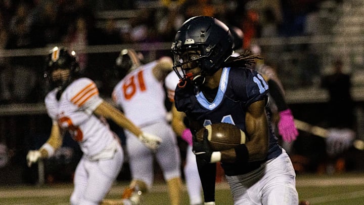 Guilford's Messiah Tilson (11) runs around defense during a game against Harlem on Friday, Sept. 27, 2024, at Guilford High School. Guilford's Messiah Tilson (11) runs around defense during a game against Harlem on Friday, Sept. 27, 2024, at Guilford High School.