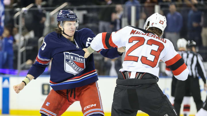 Apr 3, 2024; New York, New York, USA; New York Rangers center Matt Rempe (73) and New Jersey Devils defenseman Kurtis MacDermid (23) fight at start of the 1st period at Madison Square Garden. Mandatory Credit: Wendell Cruz-USA TODAY Sports