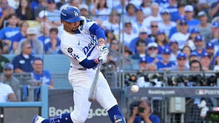 Oct 9, 2025; Los Angeles, California, USA; Los Angeles Dodgers shortstop Mookie Betts (50) singles in the sixth inning against the Philadelphia Phillies during game four of the NLDS round for the 2025 MLB playoffs at Dodger Stadium. Mandatory Credit: Jayne Kamin-Oncea-Imagn Images