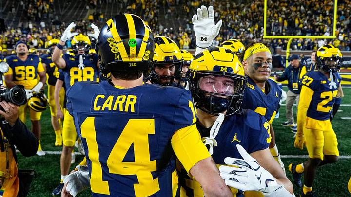 Michigan quarterback Tommy Carr (14) is congratulated by teammates after 21-18 win over Penn State at Michigan Stadium in Ann Arbor on Saturday, Oct. 17, 2026.