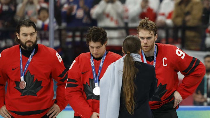 Connor McDavid (97) of Canada receives the silver medal after the men's ice hockey gold medal against the United States game during the Milano Cortina 2026 Olympic Winter Games at Milano Santagiulia Ice Hockey Arena. Mandatory Credit: Geoff Burke-Imagn Images