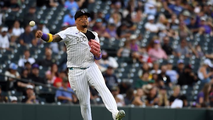 Sep 7, 2025; Denver, Colorado, USA; Colorado Rockies third baseman Orlando Arcia (11) throws to first for an out during the seventh inning against the San Diego Padres at Coors Field. Mandatory Credit: Christopher Hanewinckel-Imagn Images