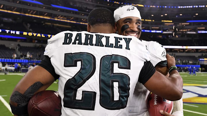 Nov 24, 2024; Inglewood, California, USA;  Philadelphia Eagles quarterback Jalen Hurts (1) hugs running back Saquon Barkley (26) in celebration after the Eagles defeat the Los Angeles Rams during the first half at SoFi Stadium. Mandatory Credit: Alex Gallardo-Imagn Images