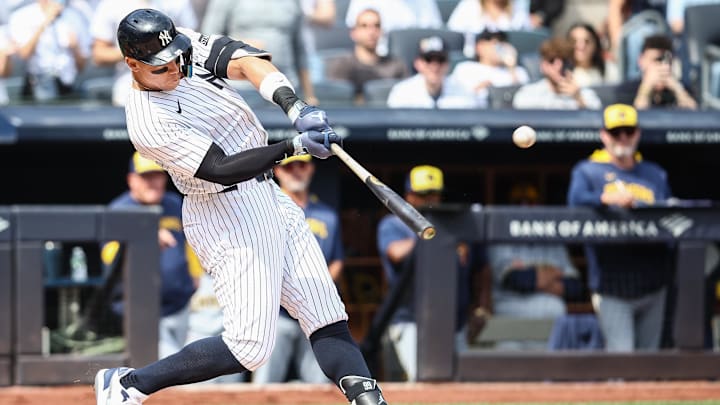 Mar 29, 2025; Bronx, New York, USA; New York Yankees right fielder Aaron Judge (99) hits a solo home run in the first inning against the Milwaukee Brewers at Yankee Stadium. 