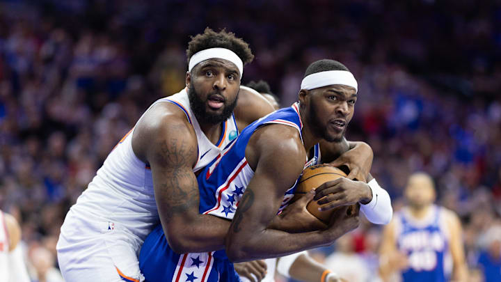 May 2, 2024; Philadelphia, Pennsylvania, USA; New York Knicks center Mitchell Robinson (23) and Philadelphia 76ers forward Paul Reed (44) wrestle for the ball during the second half of game six of the first round for the 2024 NBA playoffs at Wells Fargo Center. Mandatory Credit: Bill Streicher-Imagn Images