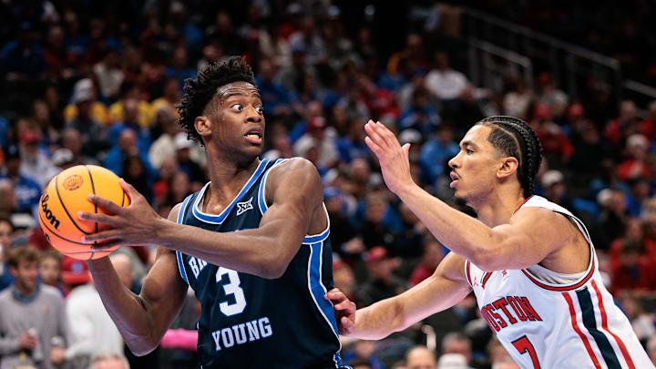 Mar 12, 2026; Kansas City, MO, USA; BYU Cougars forward AJ Dybantsa (3) protects the ball from Houston Cougars guard Milos Uzan (7) during the second half at T-Mobile Center. Mandatory Credit: William Purnell-Imagn Images
