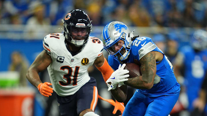 Lions running back Jahmyr Gibbs tries to elude Bears safety Kevin Byard III  on Thanksgiving Day at Ford Field.