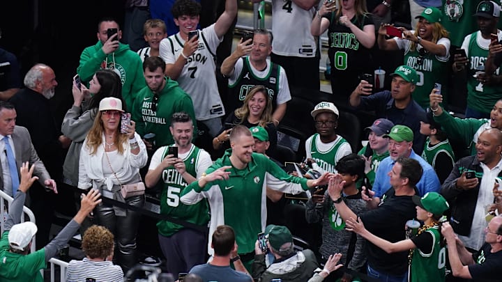 Jun 9, 2024; Boston, Massachusetts, USA; Boston Celtics center Kristaps Porzingis (8) greets fans as he walks onto the court before game two against the Dallas Mavericks in the 2024 NBA Finals at TD Garden. Mandatory Credit: David Butler II-Imagn Images Jun 9, 2024; Boston, Massachusetts, USA; Boston Celtics center Kristaps Porzingis (8) greets fans as he walks onto the court before game two against the Dallas Mavericks in the 2024 NBA Finals at TD Garden. Mandatory Credit: David Butler II-Imagn Images