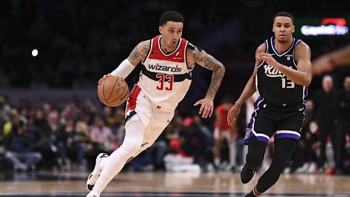 Mar 21, 2024; Washington, District of Columbia, USA; Washington Wizards forward Kyle Kuzma (33) drives to the basket as Sacramento Kings forward Keegan Murray (13) defends  during the second  half at Capital One Arena. Mandatory Credit: Tommy Gilligan-Imagn Images