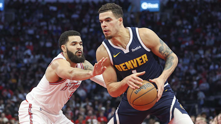 Nov 24, 2023; Houston, Texas, USA; Denver Nuggets forward Michael Porter Jr. (1) controls the ball as Houston Rockets guard Fred VanVleet (5) defends during the third quarter at Toyota Center. Mandatory Credit: Troy Taormina-Imagn Images