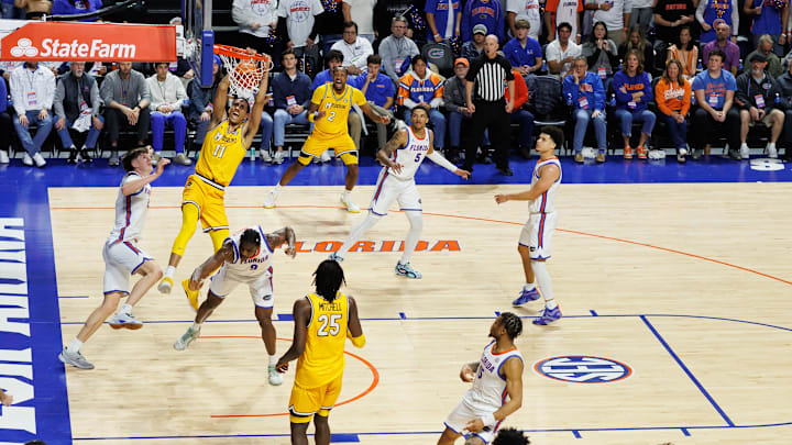 Jan 14, 2025; Gainesville, Florida, USA; Missouri Tigers guard Trent Pierce (11) dunks the ball over Florida Gators forward Alex Condon (21) and Florida Gators center Rueben Chinyelu (9) during the second half at Exactech Arena at the Stephen C. O'Connell Center. Mandatory Credit: Matt Pendleton-Imagn Images Jan 14, 2025; Gainesville, Florida, USA; Missouri Tigers guard Trent Pierce (11) dunks the ball over Florida Gators forward Alex Condon (21) and Florida Gators center Rueben Chinyelu (9) during the second half at Exactech Arena at the Stephen C. O'Connell Center. Mandatory Credit: Matt Pendleton-Imagn Images