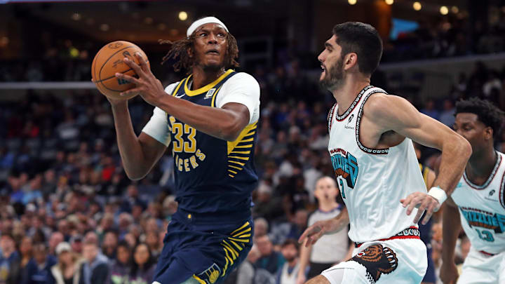 Dec 1, 2024; Memphis, Tennessee, USA; Indiana Pacers center Myles Turner (33) spins toward the basket as Memphis Grizzlies forward Santi Aldama (7) defends during the third quarter at FedExForum. Mandatory Credit: Petre Thomas-Imagn Images