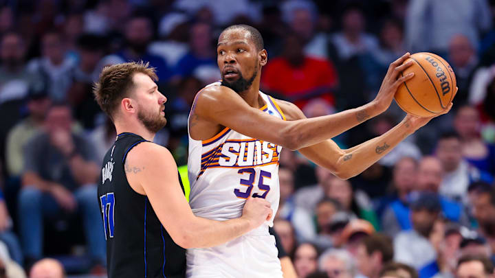 Feb 22, 2024; Dallas, Texas, USA;  Phoenix Suns forward Kevin Durant (35) controls the ball as Dallas Mavericks guard Luka Doncic (77) defends during the first half at American Airlines Center. Mandatory Credit: Kevin Jairaj-Imagn Images
