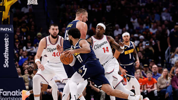 Denver Nuggets guard Jamal Murray (27) controls the ball as center Nikola Jokic (15) screens against Los Angeles Clippers guard Terance Mann (14) and center Ivica Zubac (40) in the first quarter at Ball Arena. Mandatory Credit: Isaiah J. Downing-Imagn Images Denver Nuggets guard Jamal Murray (27) controls the ball as center Nikola Jokic (15) screens against Los Angeles Clippers guard Terance Mann (14) and center Ivica Zubac (40) in the first quarter at Ball Arena. Mandatory Credit: Isaiah J. Downing-Imagn Images