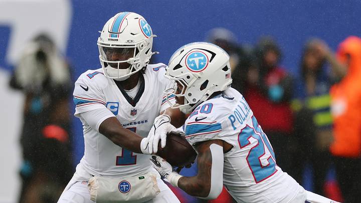 Sep 27, 2026; East Rutherford, New Jersey, USA;  Tennessee Titans quarterback Cam Ward (1) hands off the ball to running back Tony Pollard (20) against the New York Giants during the first quarter at MetLife Stadium.  Mandatory Credit: Vincent Carchietta-Imagn Images