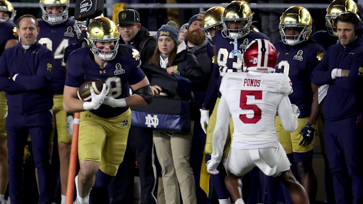 Dec 20, 2024; Notre Dame, Indiana, USA; Notre Dame Fighting Irish tight end Mitchell Evans (88) runs against Indiana Hoosiers defensive back D'Angelo Ponds (5) during the second half at Notre Dame Stadium. Mandatory Credit: Trevor Ruszkowski-Imagn Images