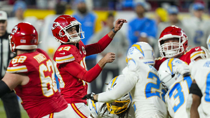 Dec 8, 2024; Kansas City, Missouri, USA; Kansas City Chiefs place kicker Matthew Wright (49) kicks a game winning field goal as time expires against the Los Angeles Chargers at GEHA Field at Arrowhead Stadium. Mandatory Credit: Jay Biggerstaff-Imagn Images