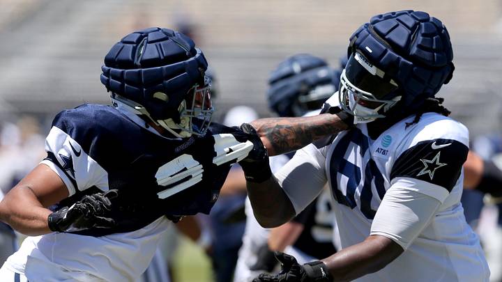 Dallas Cowboys defensive end Marshawn Kneeland and offensive tackle Tyler Guyton battle during training camp in Oxnard