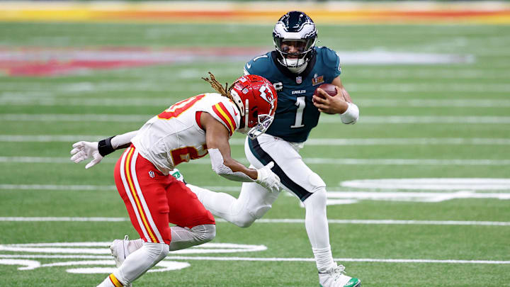 Feb 9, 2025; New Orleans, LA, USA; Philadelphia Eagles quarterback Jalen Hurts (1) runs with the ball against Kansas City Chiefs safety Justin Reid (20) during the first half of Super Bowl LIX at Caesars Superdome. 