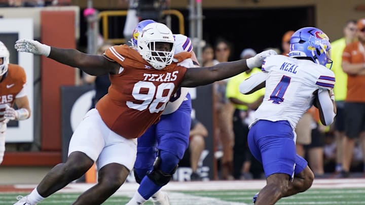 Sep 30, 2023; Austin, Texas, USA; Texas Longhorns defensive lineman Trill Carter (98) reaches for Kansas Jayhawks running back Devin Neal (4) during the second half at Darrell K Royal-Texas Memorial Stadium. Mandatory Credit: Scott Wachter-Imagn Images