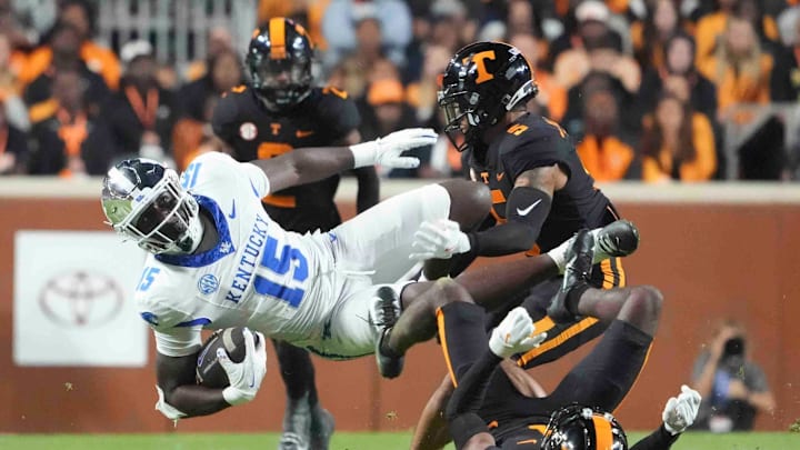 Nov 2, 2024; Knoxville, Tennessee, USA; Kentucky Wildcats tight end Khamari Anderson (15) is tackled by Tennessee Volunteers defensive back Christian Harrison (5) during the first half at Neyland Stadium. Mandatory Credit: Caitie McMekin/USA TODAY Network via Imagn Images
