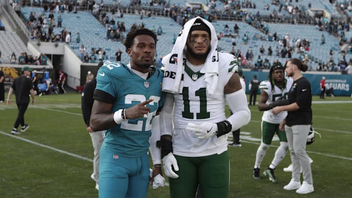 Dec 14, 2025; Jacksonville, Florida, USA; Jacksonville Jaguars cornerback Jarrian Jones (22) and New York Jets linebacker Jermaine Johnson (11) after the game at EverBank Stadium. Mandatory Credit: Travis Register-Imagn Images