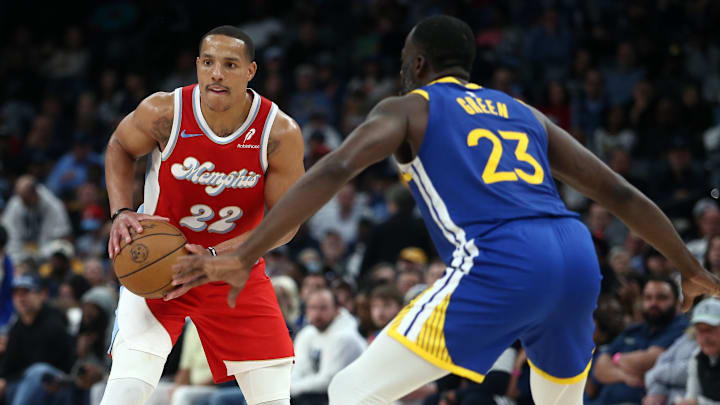 Apr 1, 2025; Memphis, Tennessee, USA; Memphis Grizzlies guard Desmond Bane (22) handles the ball as Golden State Warriors forward Draymond Green (23) defends during the second quarter at FedExForum. Mandatory Credit: Petre Thomas-Imagn Images