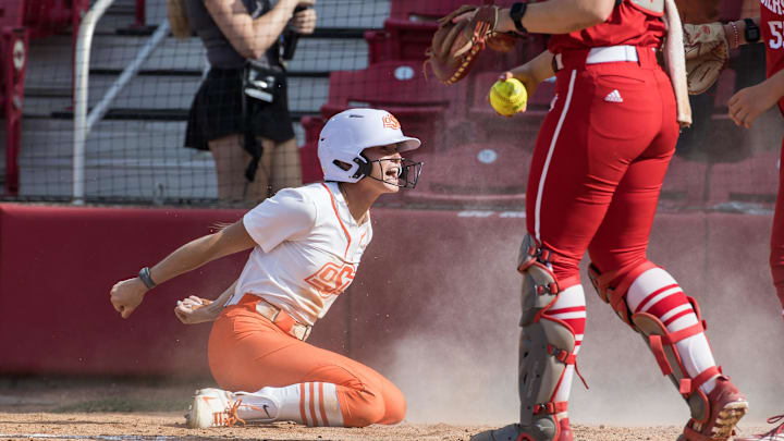 May 16, 2025; Fayetteville, AR, USA;  Oklahoma State Cowgirls outfielder Tia Warsop (9) reacts after scoring during the sixth inning agains the Indiana Hoosiers. Oklahoma State won 11-6.  Mandatory Credit: Brett Rojo-Imagn Images