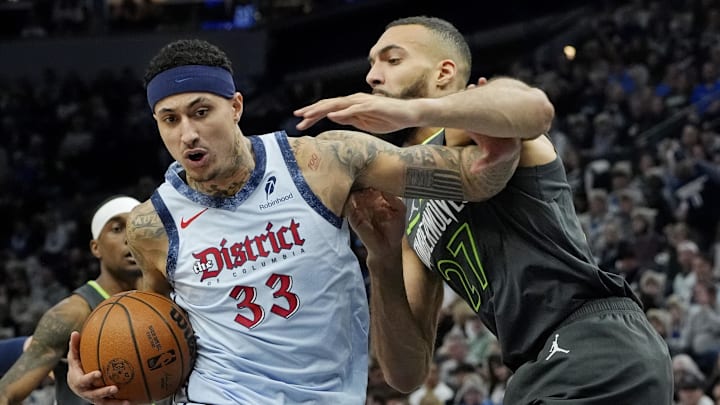 Feb 1, 2025; Minneapolis, Minnesota, USA; Washington Wizards forward Kyle Kuzma (33) goes to the basket against Minnesota Timberwolves center Rudy Gobert (27) in the first quarter at Target Center. Mandatory Credit: Bruce Kluckhohn-Imagn Images