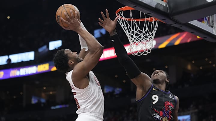 Feb 12, 2025; Toronto, Ontario, CAN; Toronto Raptors guard RJ Barrett (9)defends against Cleveland Cavaliers guard Donovan Mitchell (45) during the second half at Scotiabank Arena. Mandatory Credit: John E. Sokolowski-Imagn Images