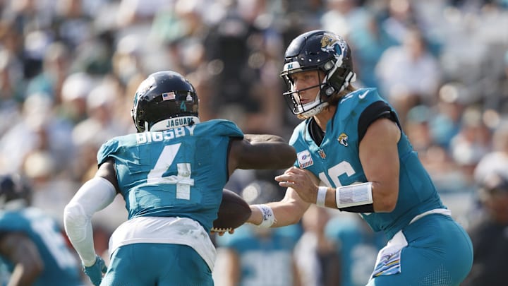 Oct 27, 2024; Jacksonville, Florida, USA; Jacksonville Jaguars quarterback Trevor Lawrence (16) hands the ball off to running back Tank Bigsby (4) against the Green Bay Packers during the third quarter at EverBank Stadium. Mandatory Credit: Morgan Tencza-Imagn Images