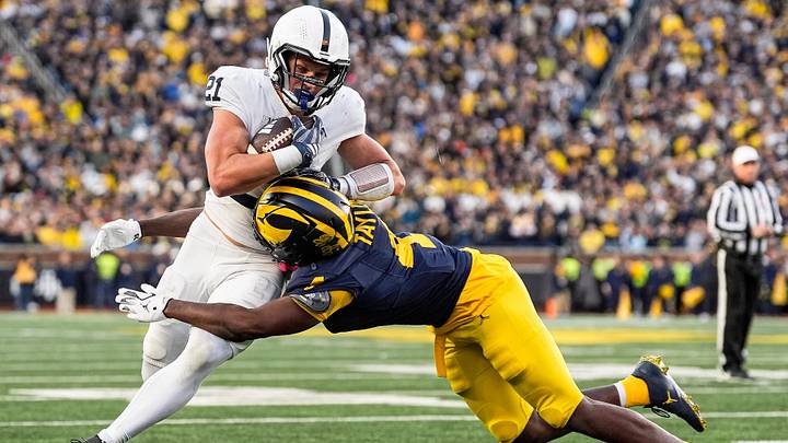 Michigan Wolverines linebacker Chase Taylor (4) tackles Penn State Nittany Lions running back Carson Hansen (21) during the second half at Michigan Stadium. Michigan Wolverines linebacker Chase Taylor (4) tackles Penn State Nittany Lions running back Carson Hansen (21) during the second half at Michigan Stadium.
