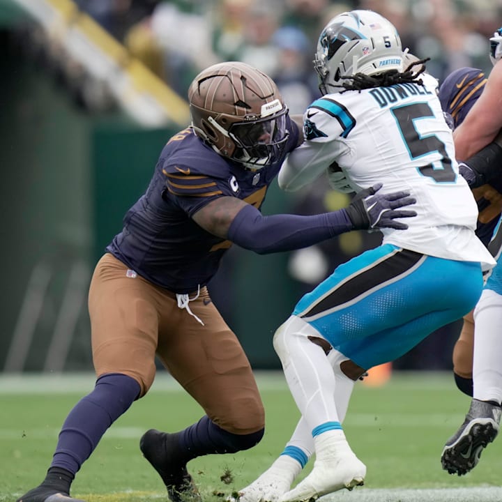 Green Bay Packers linebacker Quay Walker (7) tackles Carolina Panthers running back Rico Dowdle.