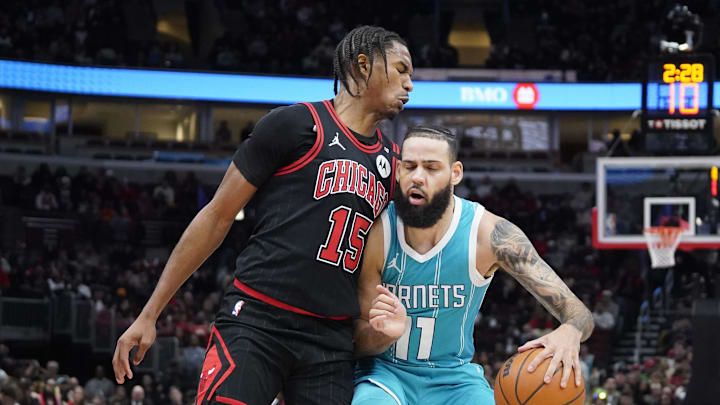 Jan 17, 2025; Chicago, Illinois, USA; Chicago Bulls forward Julian Phillips (15) defends Charlotte Hornets forward Cody Martin (11) during the second half at United Center. Mandatory Credit: David Banks-Imagn Images