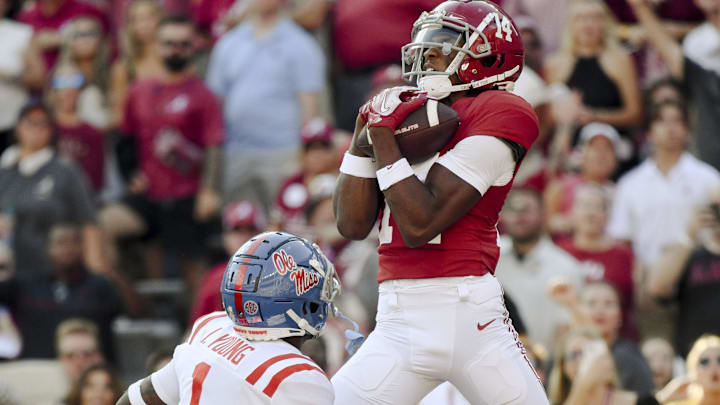 Sep 23, 2023; Tuscaloosa, Alabama, USA;  Alabama Crimson Tide wide receiver Jalen Hale (14) snags a touchdown pass from Alabama Crimson Tide quarterback Jalen Milroe (4) over Mississippi Rebels safety Isheem Young (1) at Bryant-Denny Stadium. Alabama defeated Mississippi 24-10. Mandatory Credit: Gary Cosby Jr.-Imagn Images