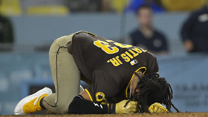 Jun 19, 2025; Los Angeles, California, USA; San Diego Padres right fielder Fernando Tatis Jr. (23) reacts as he is hit by a pitch in the eighth inning against the Los Angeles Dodgers at Dodger Stadium. Mandatory Credit: Jayne Kamin-Oncea-Imagn Images Jun 19, 2025; Los Angeles, California, USA; San Diego Padres right fielder Fernando Tatis Jr. (23) reacts as he is hit by a pitch in the eighth inning against the Los Angeles Dodgers at Dodger Stadium. Mandatory Credit: Jayne Kamin-Oncea-Imagn Images