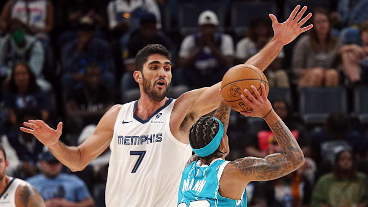 Oct 10, 2024; Memphis, Tennessee, USA; Memphis Grizzlies forward Santi Aldama (7) defends as Charlotte Hornets guard Tre Mann (23) shoots during the second half at FedExForum. Mandatory Credit: Petre Thomas-Imagn Images