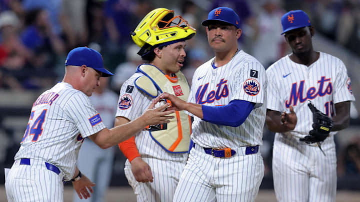 Aug 4, 2025; New York City, New York, USA; New York Mets manager Carlos Mendoza (64) takes the ball from starting pitcher Sean Manaea (59) during a pitching change during the sixth inning against the Cleveland Guardians at Citi Field. Mandatory Credit: Brad Penner-Imagn Images