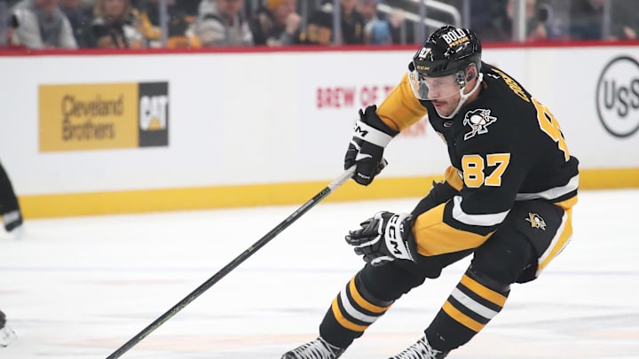 Feb 4, 2025; Pittsburgh, Pennsylvania, USA;  Pittsburgh Penguins center Sidney Crosby (87) handles the puck against the New Jersey Devils during the third period at PPG Paints Arena. Mandatory Credit: Charles LeClaire-Imagn Images